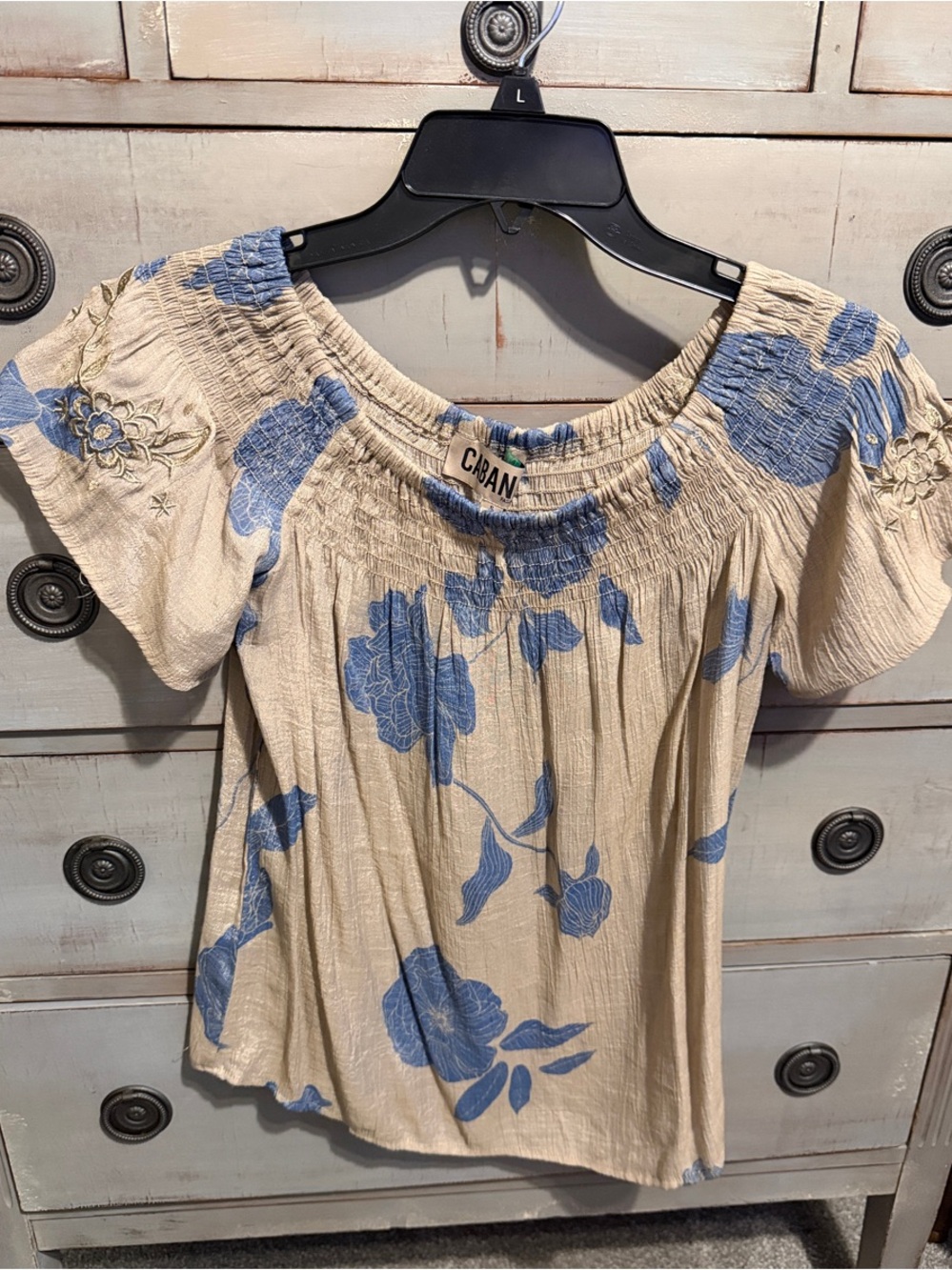 A Floral Off-Shoulder Blouse in beige and Blue